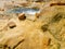 Texture of mineral deposits and View of the beach with natural baths with hot healing springs at the Greek Spa resort Loutra Edips