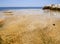 Texture of mineral deposits and View of the beach with natural baths with hot healing springs at the Greek Spa resort Loutra Edips