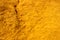 texture of ocher sand full of prints of intense yellow