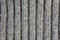 Texture ofo woolen knitwear with  large pattern `elastic band`, gray, vertical line, ,  close-up.