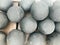 Texture of old antique combat round gray metallic, iron, stone cannon balls, ammunition. The background