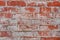 Texture of an old brick wall. Grunge red stone wall background. Old masonry, shabby facade. Vintage red brick wall