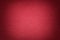 Texture of old bright red paper background, closeup. Structure of dense cardboard