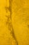 Texture of old concrete wall painted into deep Vibrant warm golden yellow color. Decorative plaster. Abstract design grunge