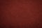 Texture of old dark red paper background, closeup. Structure of dense maroon cardboard