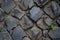 The texture of the old road. Gray cobblestones of paving stones, sometimes blackened by time.