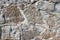 Texture of an old stone wall coated with cement residues