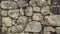 Texture of old stones of various forms with seams. Close up of shabby masonry. Stone wall from uneven different ancient