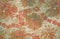 Texture of the old tapestry fabric with faded red floral pattern