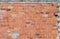 Texture of old wall wall with broken clay bricks orange