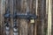 Texture of an old wooden gate with a large lock.