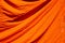 texture of orange robe of a Buddhist monk or novice for background