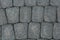 The texture of paving stone masonry, close up, top view. Exterior floor covering. Pavement background