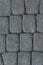 The texture of paving stone masonry, close up, top view. Exterior floor covering. Pavement background