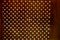 Texture of Perforated rusty iron sheet befor light. Surface of industrial mesh