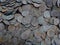 Texture of a pile of old silver coins in the ground