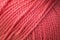 Texture of pink fluffy woolen threads for knitting.