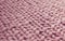 Texture of pink knit blanket. Large knitting. Plaid merino wool.