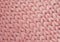 Texture of pink knit blanket. Large knitting. Plaid merino wool. Top view