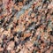 Texture of the polished surface of a red boulder, macro shot