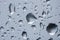 The texture of rain drops on the glass close-up. Macro transparent water drops on white background