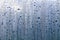 Texture of rain drops on a glass wet transparent surface