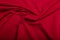 Texture of red cotton wrinkled fabric, background or backdrop. Clothing, sewing, gressmaking, haberdashery. Copy space.