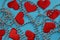 Texture of red hearts with beads on a blue background