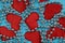 Texture of red hearts with beads on a blue background