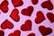 Texture of red hearts on a pink background