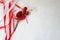 Texture red shiny artificial decorative flower decorated with balls with red and white beautiful festive ribbons made of artificia