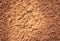 Texture of red soil, close up. Brown cement surface. Rock pattern. Weathered mud, macro.