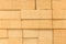 Texture of refractory sand-colored brick blocks wall closeup, background