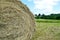 Texture round natural dried dry haystack straw dry grass village farm against a blue sky clouds Harvesting animal feed background