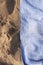 Texture of sand and towel, on the beach of Arrigunaga, Spain