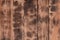 The texture of the scorched wooden wall. Wall of smooth orange long wooden boards with a specific black texture of fryin