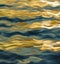 Texture of sea waves reflecting the evening sun.