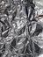 Texture of silver crumpled foil; candy wrapper