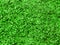 Texture of small sawdust in green color. Artistic object. Designer material.