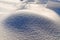 Texture of the snow mound. At sunlight snowflakes glisten