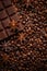 Texture spilling coffee beans, chocolate, cinnamon and cloves. Top view. Copy space