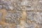 The texture of the stone masonry of the medieval walls, beige and grey