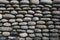 The texture of the stone wall, masonry of natural oval stones