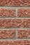 The texture of the stone wall of red granite crumbs, imitation of brick masonry