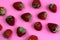 Texture strawberry on a pink background. Ripe fresh strawberry berries close-up. View from above