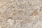 The texture of the surface of natural stone, close-up. Building material of ancient civilizations. Background. Spaces for text