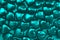 Texture of turquoise hearts on a turquoise background