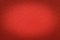 Texture of vintage red paper gradient background with dark vignette. Structure of craft ruby cardboard with frame