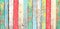 Texture of vintage wood boards with cracked paint of white, red, orange, yellow, cyan and blue color