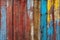 Texture of vintage wood boards with cracked paint of white, red, yellow and blue color, with copy space. AI generated image.